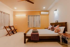 a bedroom with a large bed and a table at Par-X Mist View 9A Garden Villa 3BHK in Lonavala