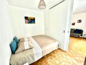a bedroom with a bed in a white room at Renovated Charming Apt Ideal to visit Paris in Clichy