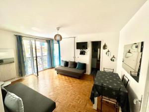a living room with a table and a couch at Renovated Charming Apt Ideal to visit Paris in Clichy