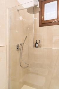 a bathroom with a shower with a glass door at Castello 5067 boutique apartment in Venice