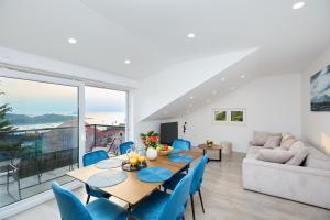 a dining room with a table and chairs and a couch at Mia Maria Apartment in Cavtat