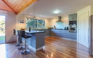 a kitchen with a island in the middle of a room at Shumadia I Private Properties in Yallingup Siding
