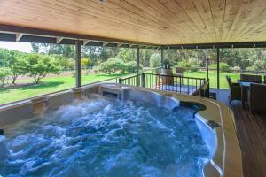 a hot tub in the middle of a patio at Shumadia I Private Properties in Yallingup Siding
