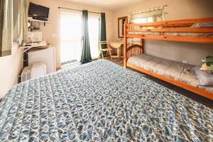 a bedroom with a bed and a bunk bed at Cabin 2 Lynn View Lodge in Haines