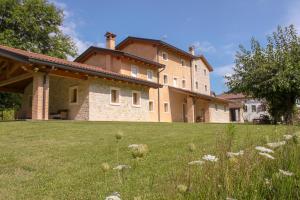 a large house on a grassy field in front at Gai De Sora Bio charming B&B in Miane