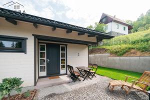 a patio with chairs and a table next to a house at Hedera Sovata in Sovata