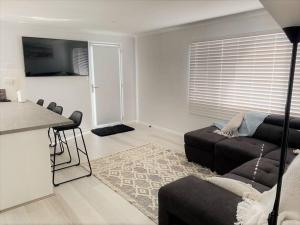 a living room with a couch and a table at Salt & Soul Beach Shack in Esperance