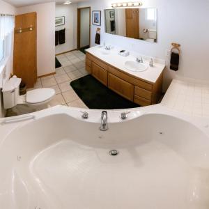 a large bathroom with two sinks and a tub at Suite 2 Lynn View Lodge in Haines