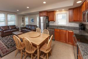 a kitchen and dining room with a table and chairs at Carriage House at One Long Beach in York Beach