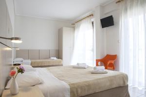 Ένα ή περισσότερα κρεβάτια σε δωμάτιο στο Ξενοδοχείο Μαυρίδης