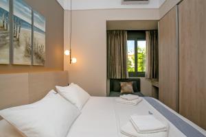 a hotel room with a bed and a window at Thalia by Heloni Apartments in Athens