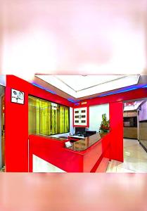 a kitchen with red walls and a red counter at Swapna International in Mumbai
