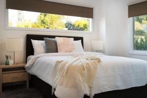 a bedroom with a large bed with a window at Musk Springs in Bullarto
