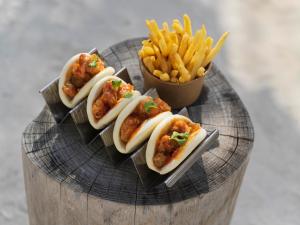three hot dogs and french fries on a plate at The Ritz-Carlton Maldives, Fari Islands in North Male Atoll