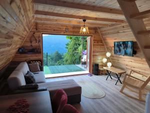 a living room with a couch and a large window at Neyla Suit in Arhavi