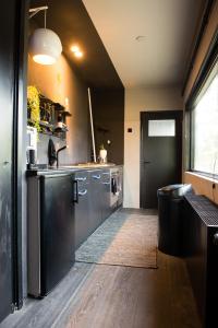 a large kitchen with stainless steel appliances in a room at Bijzonder stadshuis met diepe moderne tuin. in Alphen aan den Rijn