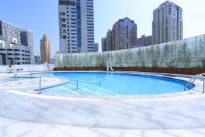 a swimming pool in the middle of a city at Renaissance Shenzhen Luohu Hotel in Shenzhen