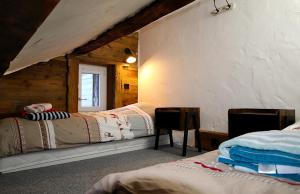 a bedroom with two beds in a wooden cabin at Chalet le Chantelevent for 24 Guests - Slope Views, Pool & Jacuzzi in Vars +54 photos