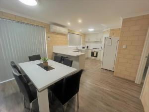 a kitchen with a table and chairs in a room at Stay By The Sea Esperance in Esperance