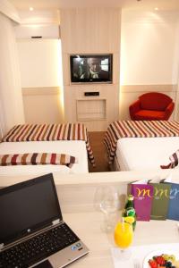 a hotel room with two beds and a laptop at Mercure Brasilia Lider in Brasília