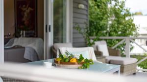 a bowl of fruit on a table on a porch at Lakeside Suite 1 - Lake View & Spa Bath in Daylesford