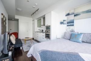 a bedroom with a large bed and a kitchen at GLOBALSTAY Gorgeous Downtown Apartment in Toronto