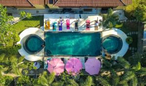 an overhead view of a swimming pool with umbrellas at Salim Beach Resort in Gili Air