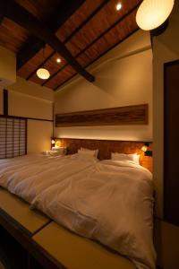 上越的住宿－‐izen 高田‐ 多賀，一张大白色的床铺,房间光线充足