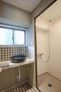 a bathroom with a sink and a shower at ZDT-406 in Tokyo