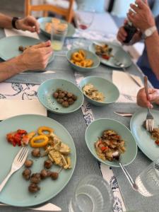 a table with plates of food on it at Calma Marína Roses in Roses +36 photos