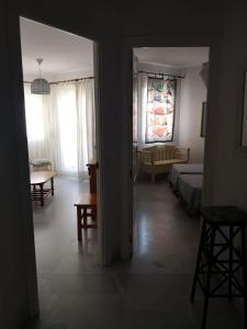 Schlafzimmer mit einem Bett, einem Tisch und einem Fenster in der Unterkunft Apartamento Aretusa Luz in Zahara de los Atunes