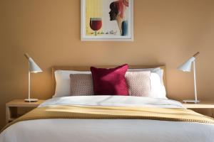 a bedroom with a large bed with two lamps at Orford Panache in Daylesford