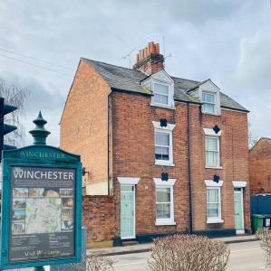 a brick building with a sign in front of it at City Centre 4 Bedroom-Sleeps 8! in Winchester
