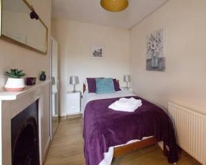 a bedroom with a bed and a fireplace at City Centre 4 Bedroom House in Winchester