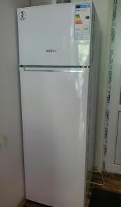 a white refrigerator in a room with a door open at Green Palma in Kutaisi