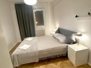 a small bedroom with a bed and a window at Nono's apartament in Cluj-Napoca