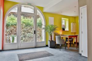 a dining room with a door and a table at Ferme du Roy in Anserville
