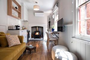 a living room with a couch and a fireplace at Persimmon in Clunes