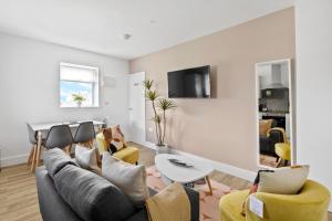 a living room with a couch and chairs and a table at Stylish Great Location Near Tamar Bridge in Saltash