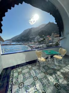 a balcony with a table and chairs and a view at Hotel Marina Riviera in Amalfi