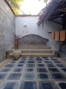 a room with a bench and a vase on the floor at CocoVilla Boutique Resort in Beruwala