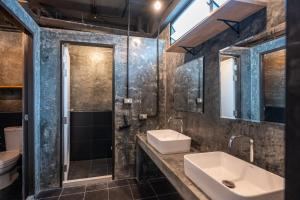 a bathroom with a sink and a mirror at Black Panther Hostel in Phuket +52 photos