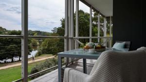 a balcony with a table and chairs and a view at Lakeside Suite 3 - Lake View & Spa Bath in Daylesford