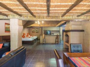Cette grande chambre dispose d'un salon avec une cheminée. dans l'établissement Motozi Lodge, à Pelindaba