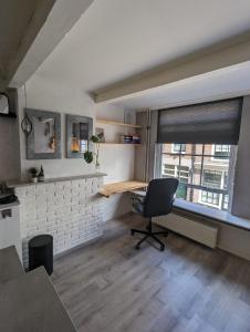 an office with a desk and a chair in a room at Monumental gem in the heart of Utrecht City in Utrecht