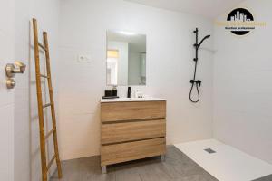 a bathroom with a sink and a mirror at Apartamento Camino Lago in Torremolinos