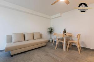 a living room with a couch and a table at Apartamento Camino Lago in Torremolinos