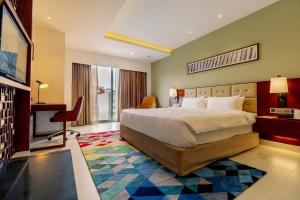 a hotel room with a bed and a desk and a television at Best Western Heritage in Cox's Bazar +27 photos