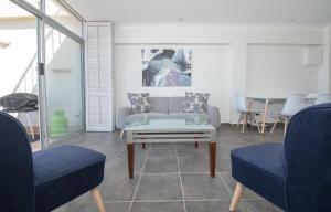 a living room with a couch and two chairs at 21 Bronze Bay Umhlanga Rocks in Durban