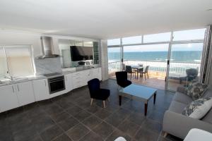 a kitchen and living room with a view of the ocean at 21 Bronze Bay Umhlanga Rocks in Durban
